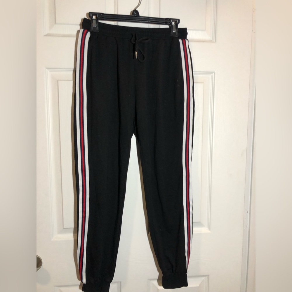 Black joggers with red and white strip